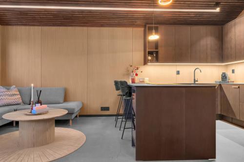 a kitchen and living room with a couch and a table at Signature Townhouse for Luxury Living Arctic Seasons in Tromsø