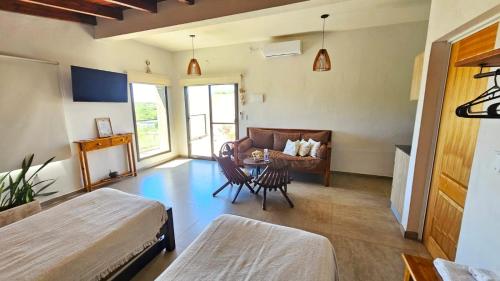 a room with a bed and a table and a couch at Terrazas al Golf in Alta Gracia