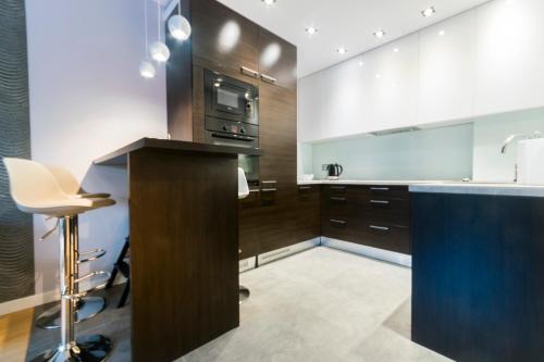 a kitchen with a counter and a stove top oven at Pohulanka Luxury in Gdańsk