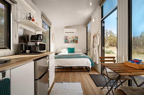 a kitchen and a bedroom with a bed in a room at Womburra Vineyard Tiny Stay by Tiny Away in Redbank