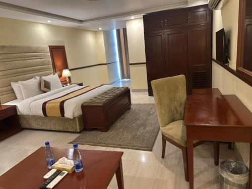 a hotel room with a bed and a desk at City Oasis Boutique Hotel in Lahore