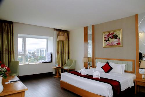 a hotel room with a large bed and a window at Sai Gon Dong Ha Hotel - a member of Saigontourist Group in Quang Tri