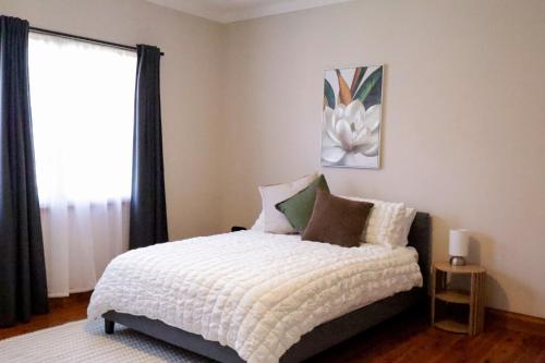 a bedroom with a bed and a window at Spacious 3-Bed Home in Central Tenterfield in Tenterfield