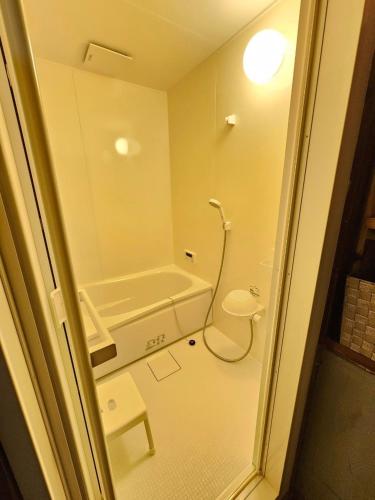 a bathroom with a shower and a toilet in it at ほしのすみか in Nikko