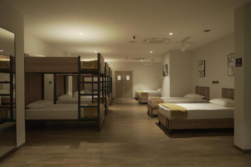 a room with several bunk beds in a room at Round D Clock, IGI Airport in New Delhi