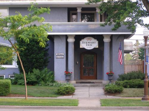 a blue house with a sign that reads stanford inn at Stewart Inn in Wausau