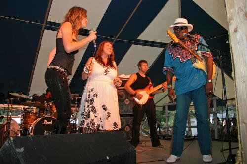 a group of people playing music on a stage at Stewart Inn in Wausau