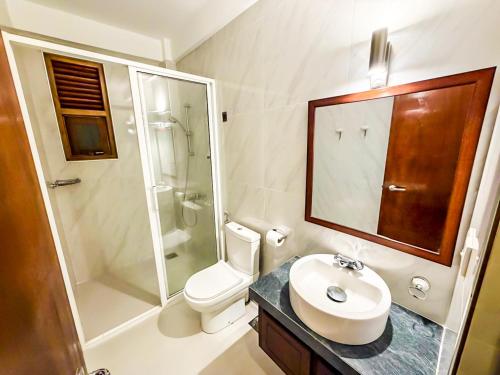 a bathroom with a toilet and a sink and a shower at Windsor in Kandy