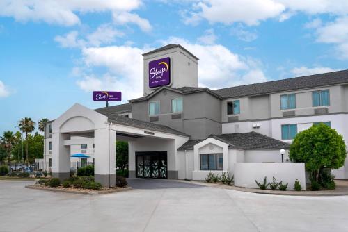a hotel with a purple sign on top of it at Sleep Inn Baton Rouge East I-12 in Baton Rouge