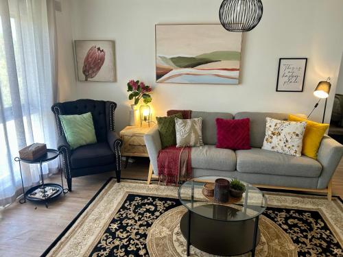 a living room with a couch and a glass table at Sunshine Seven in Salisbury