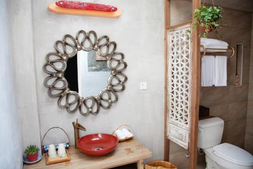 bagno con specchio, lavandino e servizi igienici di WuYuan QiYe YanXiang Guesthouse a Wuyuan