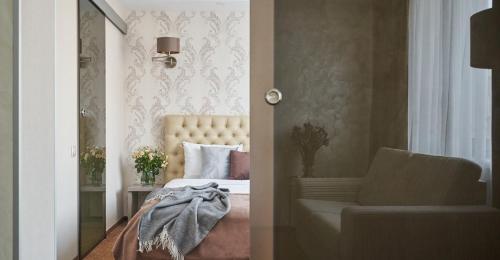 a bedroom with a bed and a couch and a chair at Готель Дружба in Kyiv