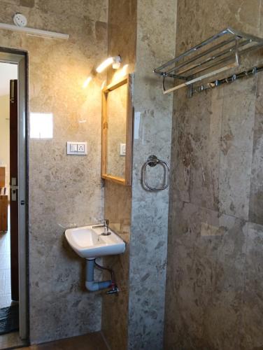 a bathroom with a sink and a shower at Longwood Resorts in Kotagiri