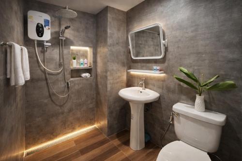 a bathroom with a shower and a toilet and a sink at Similan Mondo Resort & Camping in Phang-nga