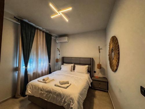 a bedroom with a bed and a ceiling fan at Siel simple elegance Volos in Volos