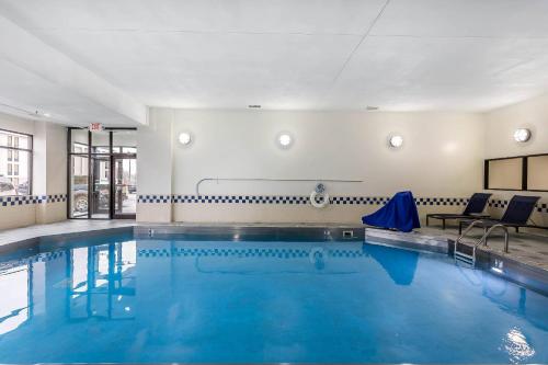 a swimming pool with blue water in a building at Comfort Inn SW Omaha I-80 in Omaha