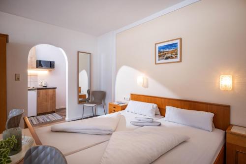 a bedroom with a large white bed in a room at Gästehaus Wildauer in Ebbs