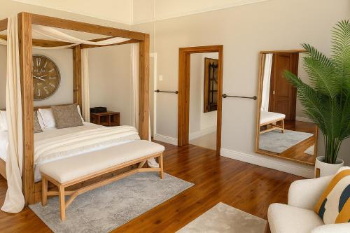 a bedroom with a bed and a mirror at The View Guesthouse & Cottage in Caledon