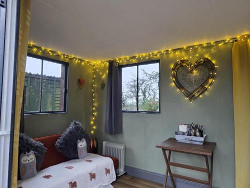 a bedroom with a heart mirror on the wall at Ty Grug Retreat in Little Newcastle