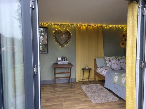 a bedroom with a bed and a table with a mirror at Ty Grug Retreat in Little Newcastle