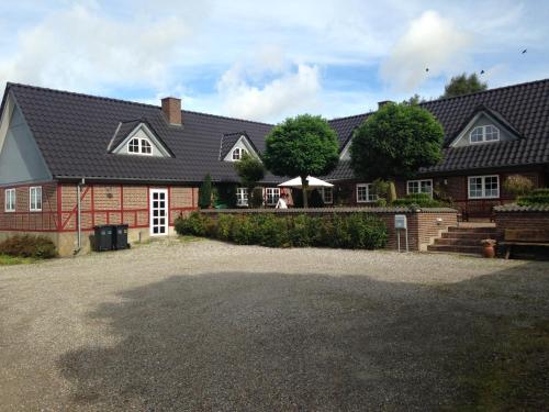 a house with a large driveway in front of it at Country B&B Horsens in Horsens