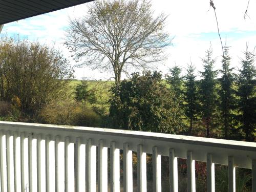 a white fence with a tree in the background at Country B&B Horsens in Horsens