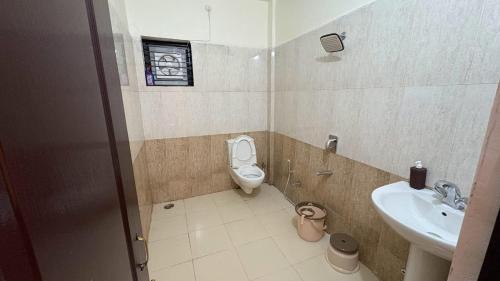 a bathroom with a toilet and a sink at Elite Villa Raipur - Luxury Homestay in Raipur