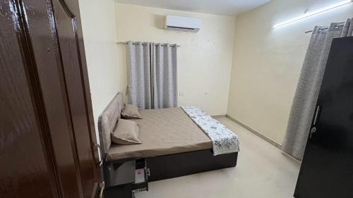 a small room with a small bed in it at Elite Villa Raipur - Luxury Homestay in Raipur