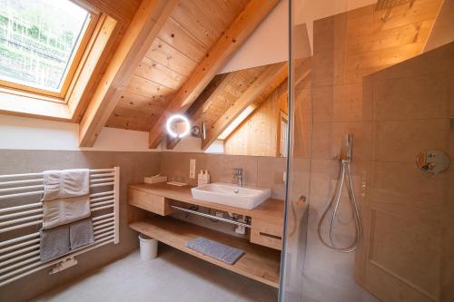 a bathroom with a sink and a shower at Panorama Hotel Himmelreich in Kastelbell-Tschars