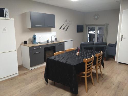 a kitchen and dining room with a table and chairs at Le domaine de Fillette in Einvaux