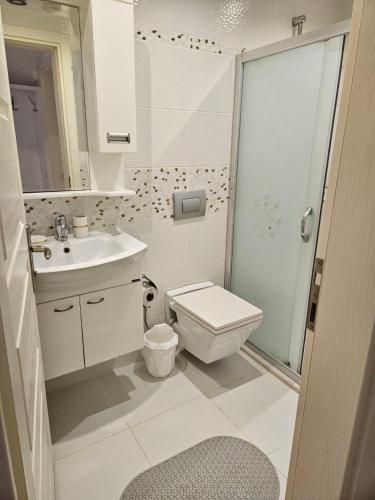 a bathroom with a toilet and a sink and a shower at Tyana Home-1 in Kaş