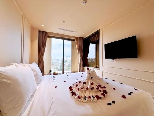 a bedroom with a bed with a pillow on it at Peace Home Boutique Hotel in Phan Thiet
