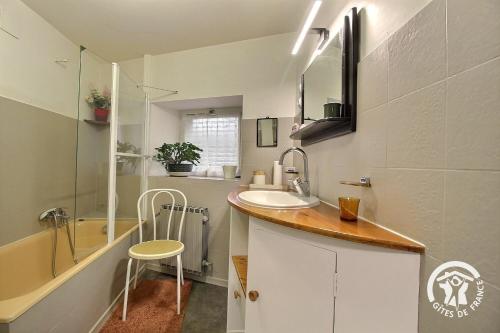 a small bathroom with a sink and a shower at Le bois du chat in Plouha