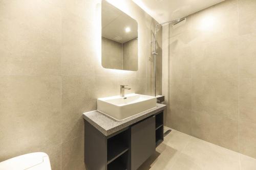 a bathroom with a sink and a mirror at Hotel Signature Gwangju in Gwangju
