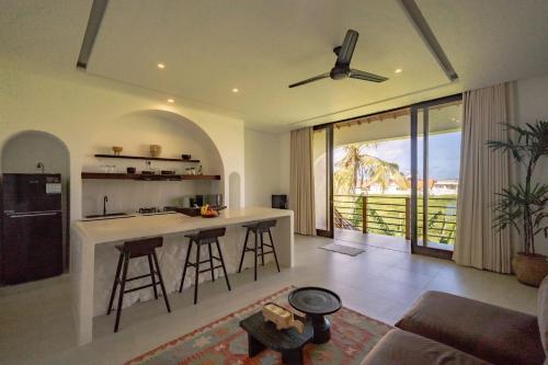 a kitchen and living room with a bar with a view at Didi Apartment Seseh in Munggu