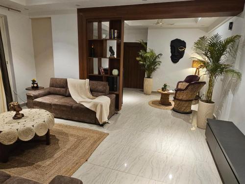 a living room with a couch and a table at The Secret Escape in Bahādurgarh
