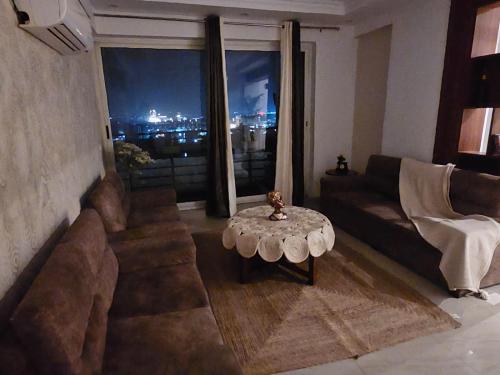 a living room with a couch and a table at The Secret Escape in Bahādurgarh