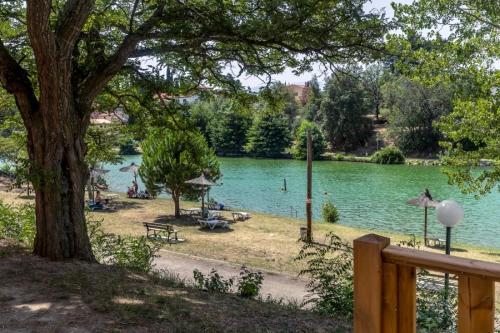 a view of a lake with people swimming in it at ZEcamping 3 étoiles animaux acceptés en bord de lac in Vinça