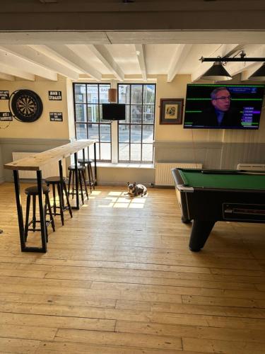 a room with a pool table and a flat screen tv at The Staging Post in Aberdeen