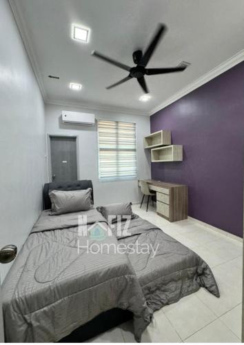 a bedroom with a bed and a ceiling fan at NAFIZ Pool Homestay Melaka - Fully AC 4 Rooms with 3 Toilets, PS4 in Kampong Alor