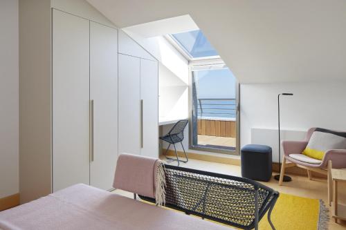 a bedroom with a bed and a view of the ocean at ATeRIAN GAZTETAPE II in Getaria