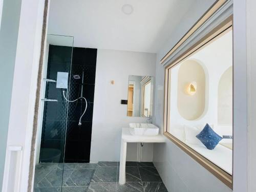 a bathroom with a sink and a shower at Big Fish Resort Koh Tao in Ko Tao