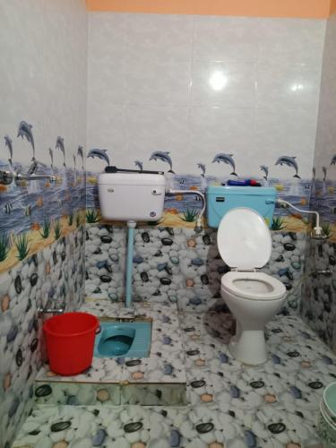 a bathroom with a toilet and a sink at Green Valley Homestay in Barkot
