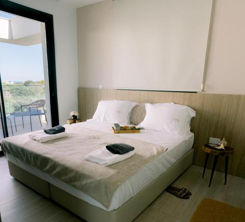 a bedroom with a bed with two towels on it at Nesea Seaside Luxury Escape in Protaras
