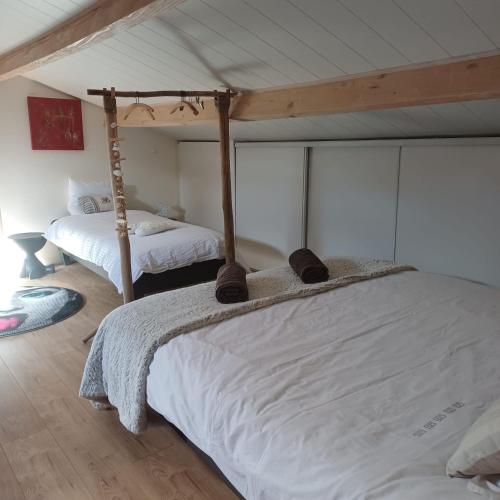 a bedroom with two beds in a room at GITE 2 personnes avec piscine in Le Bosc