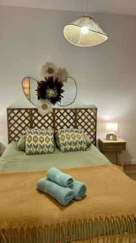 a bedroom with a bed with a towel on it at Casa Alba in Saint-Chamond