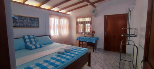 a bedroom with a bed and a table in it at HindaHaven in Weligama