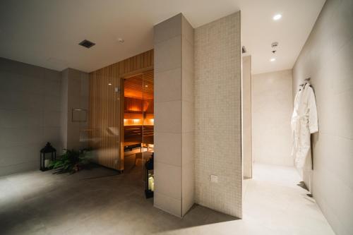 a room with a walk in closet and a wall at Hotel Crystal in Orebić