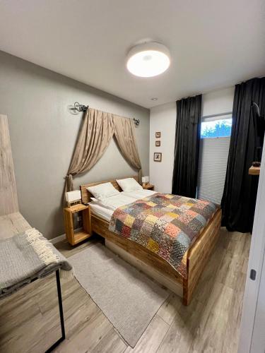 a bedroom with a bed and a window at Nieznany Bór 8 in Hajnówka