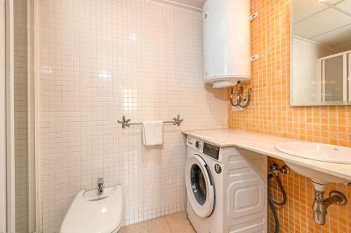 a bathroom with a washing machine and a sink at Apartment Happy Coast Moraira in Moraira